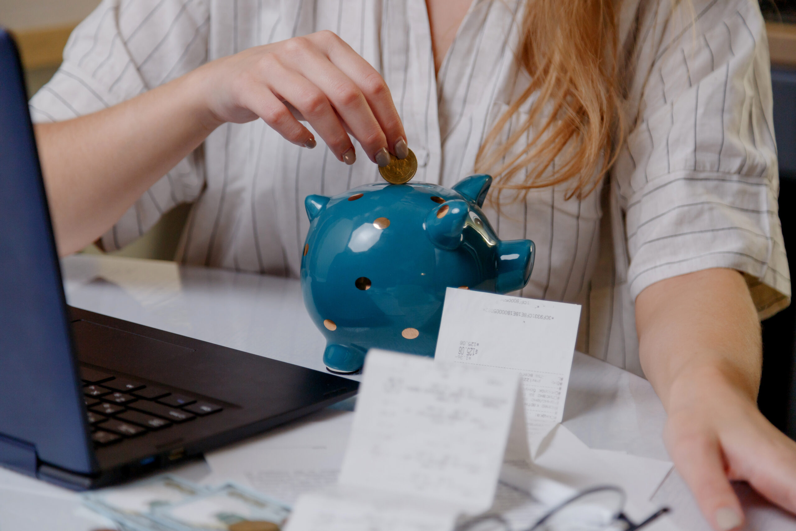 Money being placed into a piggy bank